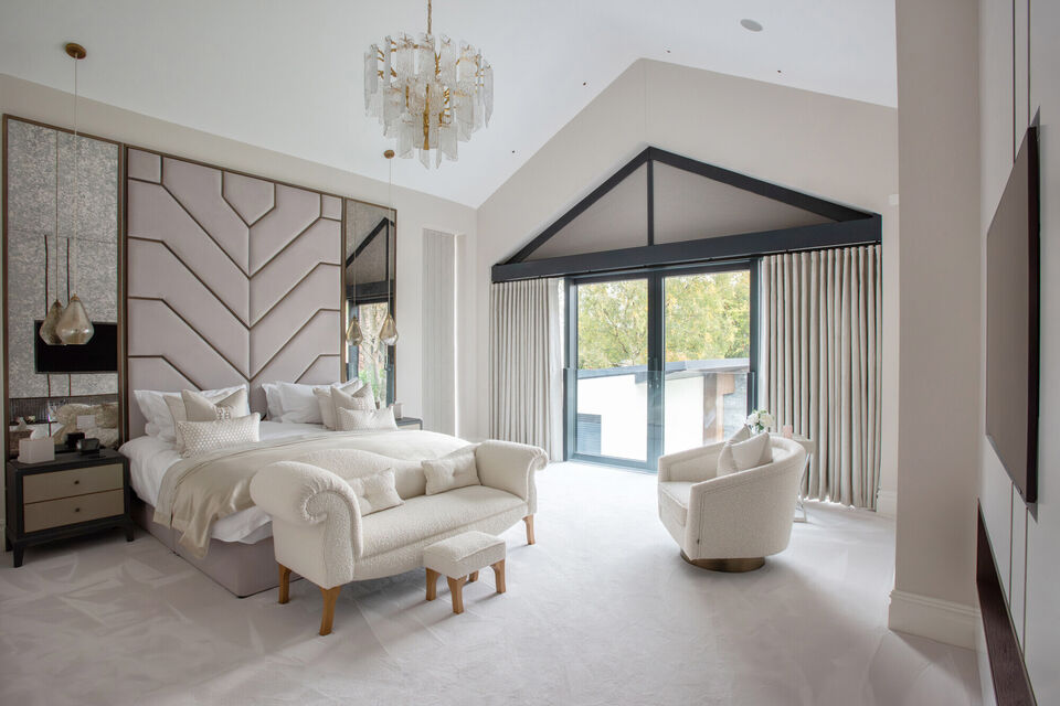 Luxury principal bedroom suite with vaulted ceiling, bespoke wall panelling and full-height glazing