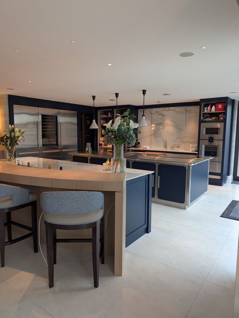 “Luxury open-plan kitchen with bespoke cabinetry, large island and integrated appliances
