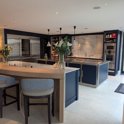 “Luxury open-plan kitchen with bespoke cabinetry, large island and integrated appliances