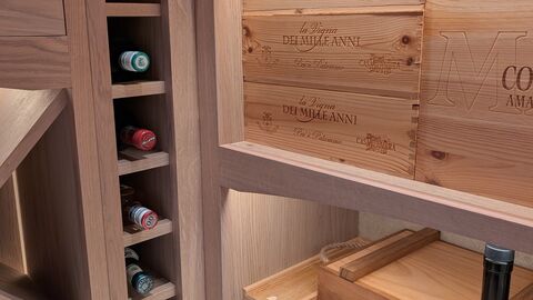 Bespoke wine storage with oak shelving, integrated bottle racks and custom joinery