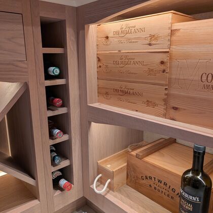 Bespoke wine storage with oak shelving, integrated bottle racks and custom joinery